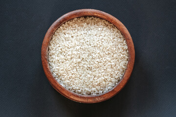 White rice in wooden bowl  top view