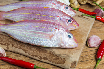 group sea bream with lemon rosemary wood table