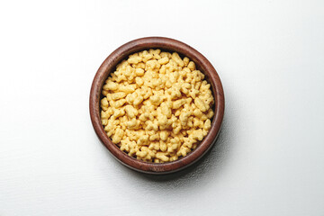Wooden bowl with quick breakfast cereal on white background