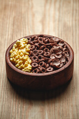 Wooden Bowl with different sorts of quick breakfast cereal products