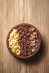 Wooden Bowl with different sorts of quick breakfast cereal products