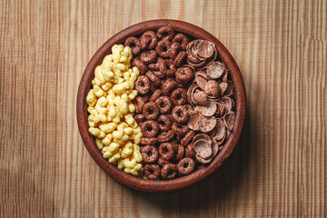 Wooden Bowl with different sorts of quick breakfast cereal products