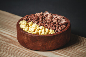Wooden Bowl with different sorts of quick breakfast cereal products