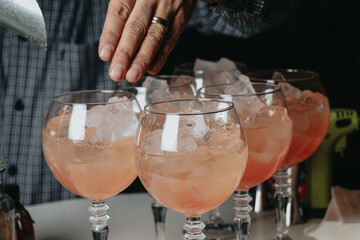 Cocktails with champagne in wine glasses on the bar table in the pub or restaurant with the...