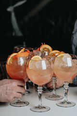 Cocktails with champagne in wine glasses on the bar table in the pub or restaurant with the bartender. 