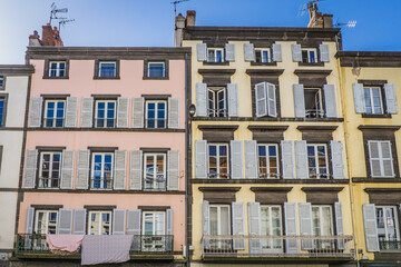 Fototapeta na wymiar typical facades of houses in the streets of Clermont Ferrand, Auvergne (France). Here the Blatin street