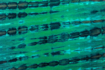 Multicolor blue, green, black textile tie dye color background. Shibori pattern concept.