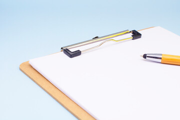 paper with a pen on a blue background. The concept of the transience of time. Business concept