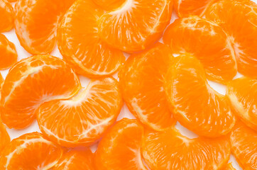 Citrus composition. Consists of tangerine slices on a white background. Top view, flat sunbed, tangerine texture, all tangerines background.