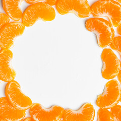 Citrus composition. Consists of tangerine slices on a white background. Top view, flat lounger, copy space.