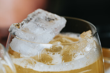 Cocktails with champagne in wine glasses on the bar table in the pub or restaurant with the bartender.
