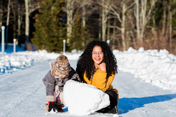 authentic portrait of a young mother and daughter in the snow