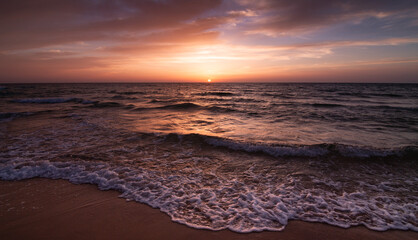 Sunset over the sea shore, sandy beach