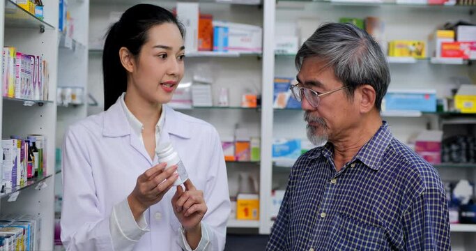 Senior man talking to female pharmacists at drugstore. Female pharmacist assisting explaining medicine to senior patient customers in pharmacy.