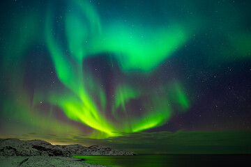 Northern lights (Aurora borealis) in the sky over the Barents Sea