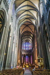 Clermont-Ferrand, France - September 17th, 2019: Inside Notre de L'Assomption Cathedral, a majectic 13th century gothic cathedral built in volcanic stone in the historic center of Clermont Ferrand.