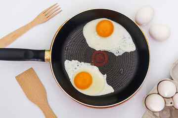 In the process of preparing breakfast with fresh eggs.