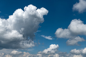 Naklejka na ściany i meble Blue sky background with fluffy clouds