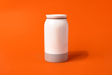 White vase on orange background, minimalistic background