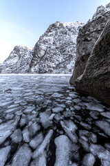 Winter landscape on a lake during Lofoten islands winter. Snow and ice melting