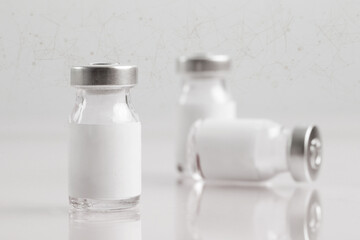 Close up image of vaccine or injection bottles with blank white label.  Vial bottle mockup....