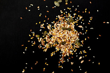 Cereal mix, sunflower, pumpkin seeds, sesame. Black background.