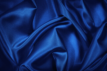 Luxurious blue silk satin background. Soft wavy folds on shiny fabric. Beautiful abstract...