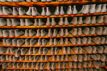 Blanks or pads for shoes are on the shelves in the cabinet in the shoe plant.