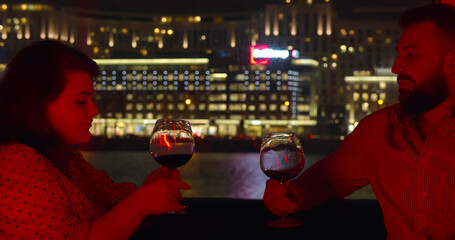 Sweet couple celebrating anniversary in romantic place with panoramic window