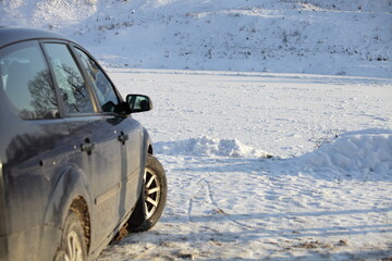 Icy river in front of a car in the snow on a winter day, vehicle safety driving on an ice crossing road