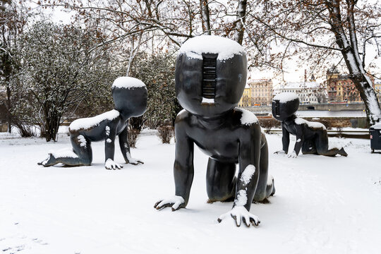 PRAGUE, CZECH REPUBLIC - JANUARY 14, 2021: Babies - Bronze scupltures installed on Kampa Island in Prague, Czech Republic. Artist: David Cerny. Sculptures covered by snow in winter