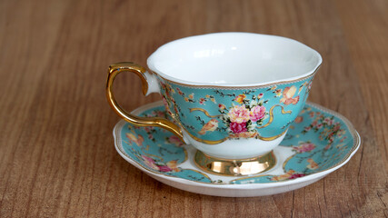 Porcelain tea and coffee cups on wood