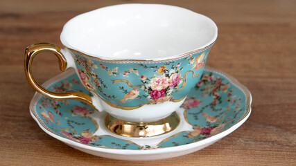 Porcelain tea and coffee cups on wood