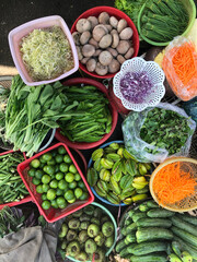 Top view on a large assortment of row loose vegetables and fruits for sale in a street. Short circuit production at Hue Market