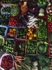 Top view on a large assortment of row loose vegetables and fruits for sale in a street. Short circuit production at Hue Market
