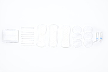 Different female hygienic products on white background. Feminine pads and tampons on white. Sanitary napkins and menstrual womens tampons