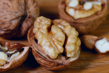 Food background. Walnut kernels close-up. Chopped nuts lie on a wooden table.