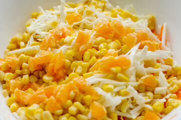 Canned corn salad with tangerines and cabbage. Close-up, homemade diet food.