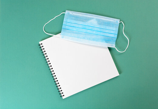 Medical mask on notebook. The concept of purchasing masks and accounting for wearing mask.