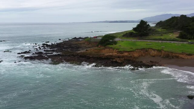 Forward Aerial Pan of Rocky Beach Shore of the California Coast Along Highway 1