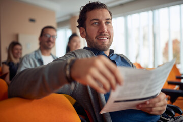 young  caucasian guy smiling at business seminar,