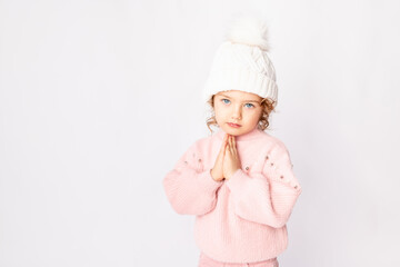 cute baby girl in pink winter clothes on white background, space for text