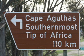 Cape Agulhas southernmost tip of Africa road sign showing direction and distance