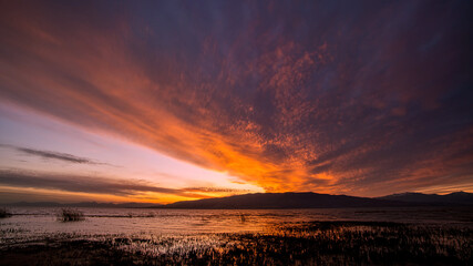 Colorful sunset over Utah Lake as the clouds glow