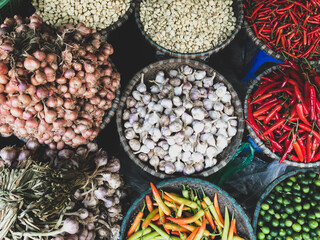 Top view on a large assortment of row loose vegetables and fruits for sale in a street. Short circuit production at Hue Market