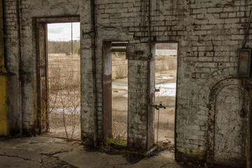 Fototapeta na wymiar Various doorways in a brick building of an abandoned factory in the deep south