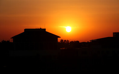 Sunset on the background of a residential building. Buildings in the shade.