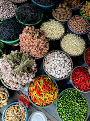 Fresh vegetables for sale at street food market in the old town of Hanoi, Vietnam. Garlic, Lemon,...