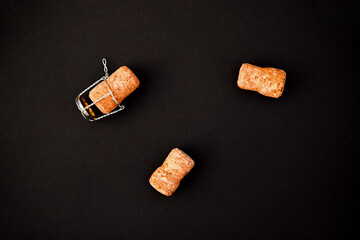 A few champagne or wine corks on a black background. Background and texture.