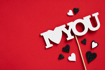 A sign that says " I love you " with hearts on the red background. St. Valentine's day background with copy space.